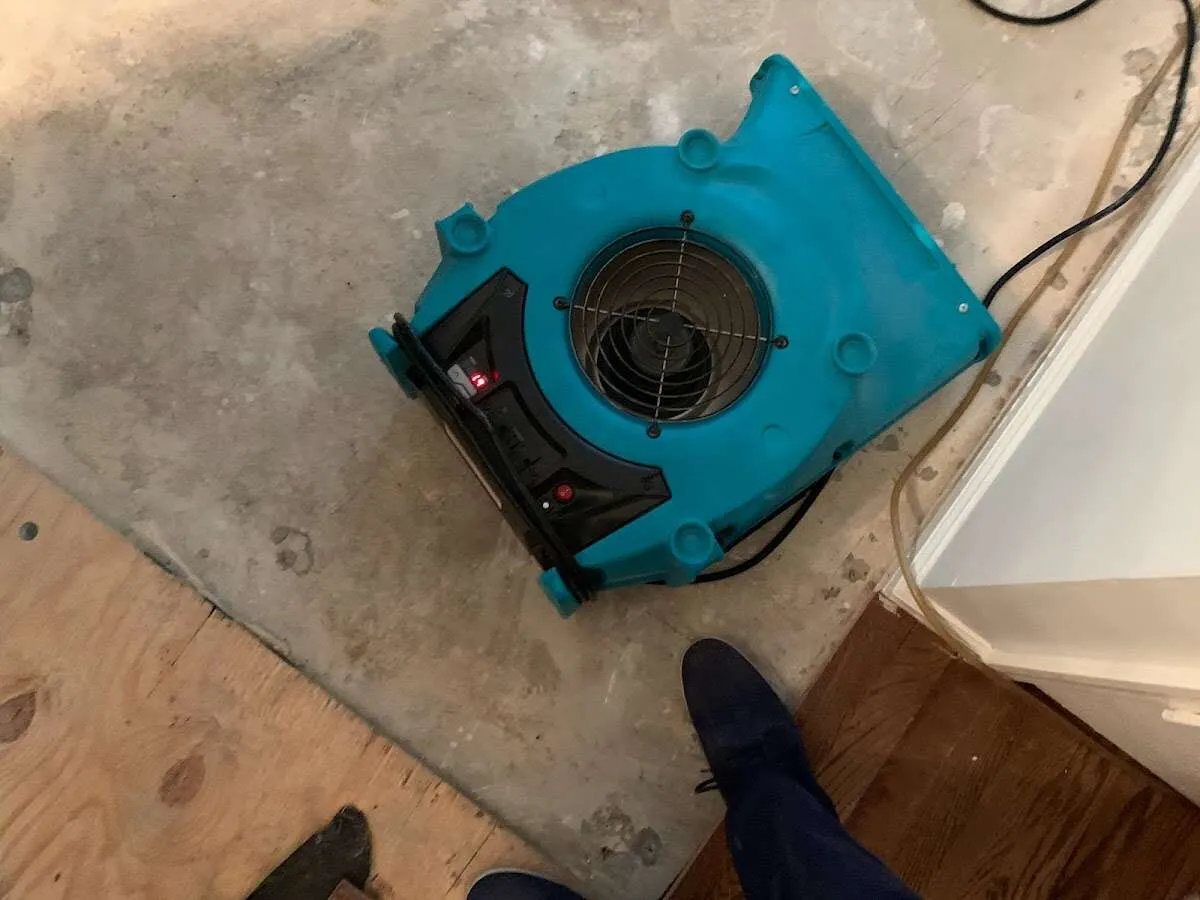 Air mover drying subfloor during Commercial Water Damage Restoration in Jeffersontown